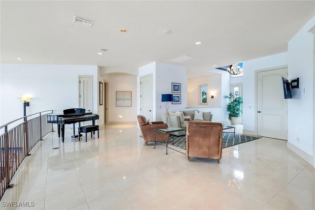 940 Tulip Ct, Marco Island, FL 34145 - living room with visible vents, baseboards, light tile patterned floors, recessed lighting, and arched walkways