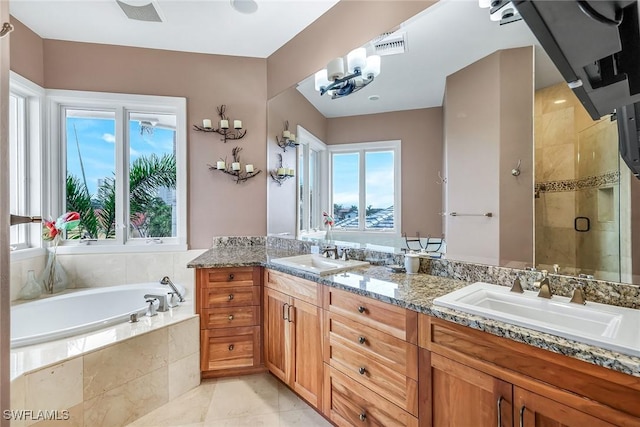 full bath with a sink, a garden tub, double vanity, and a shower stall