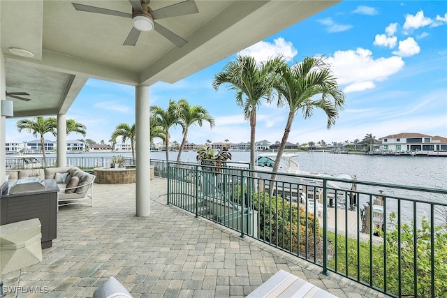 view of patio / terrace with outdoor lounge area, a balcony, a water view, and ceiling fan