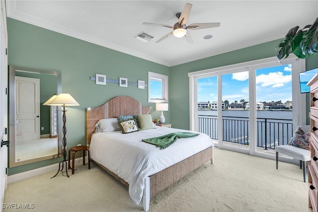 carpeted bedroom featuring visible vents, baseboards, access to exterior, and crown molding