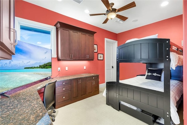 bedroom with built in desk, a ceiling fan, visible vents, and carpet floors