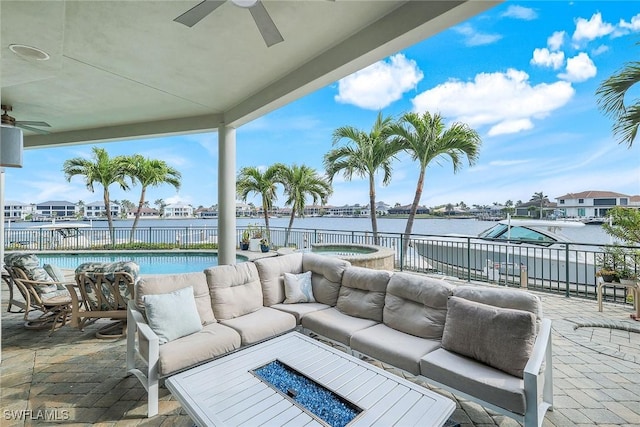 view of patio with a fenced in pool, an outdoor living space with a fire pit, a ceiling fan, and fence