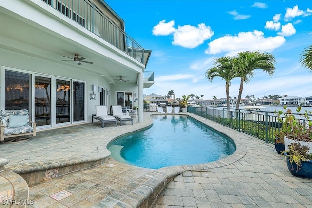 view of swimming pool with a fenced in pool, a patio, a ceiling fan, and fence