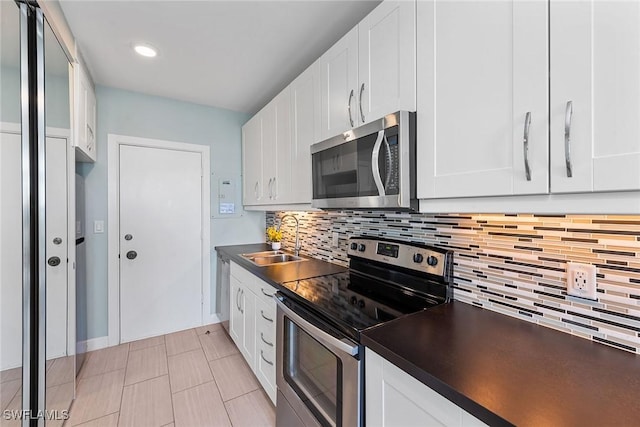 220 Seaview Ct Unit 305, Marco Island, FL 34145 - kitchen featuring a sink, stainless steel appliances, backsplash, and dark countertops