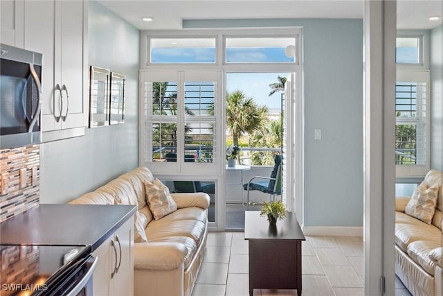 220 Seaview Ct Unit 305, Marco Island, FL 34145 - living area featuring baseboards and light tile patterned floors