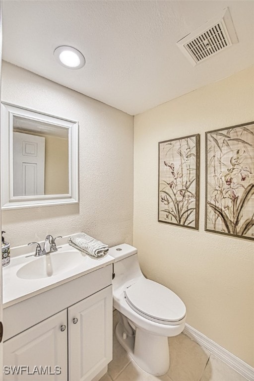 bathroom featuring tile patterned flooring, visible vents, toilet, and vanity