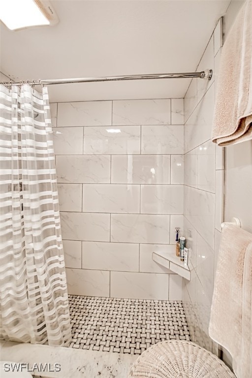 full bath with a tile shower