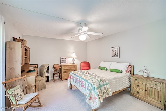 bedroom featuring light carpet and a ceiling fan