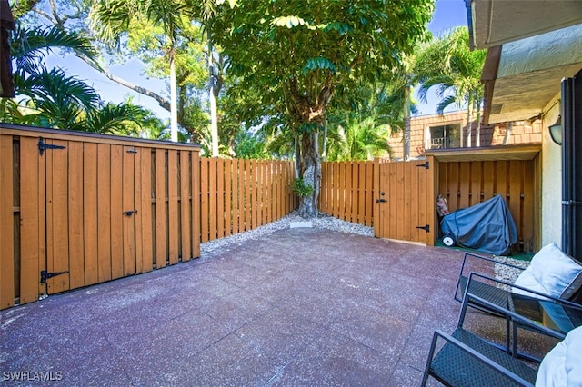 view of patio with a gate and fence