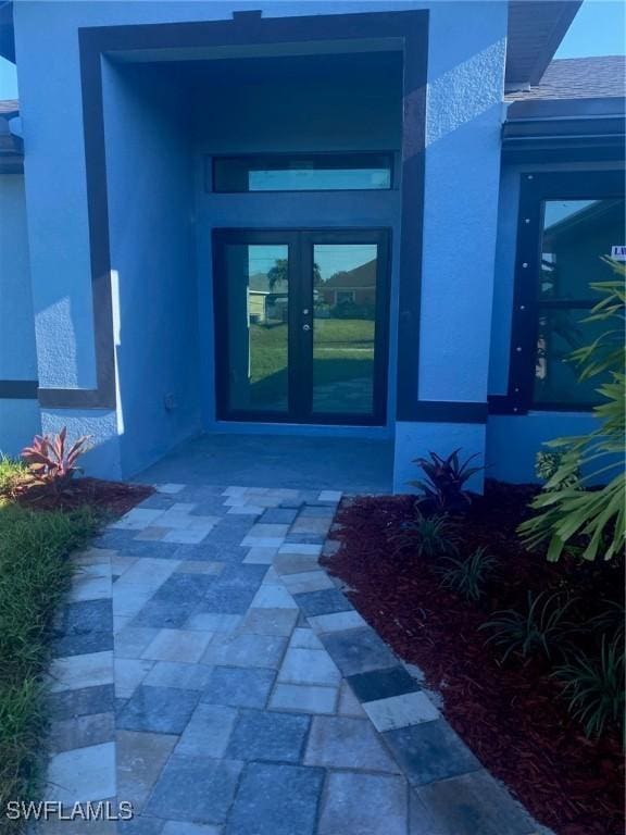 4108 35th St SW, Lehigh Acres, FL 33976 - view of exterior entry with french doors and stucco siding