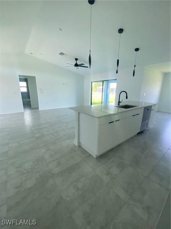 4108 35th St SW, Lehigh Acres, FL 33976 - kitchen with vaulted ceiling, open floor plan, a sink, plenty of natural light, and white cabinets