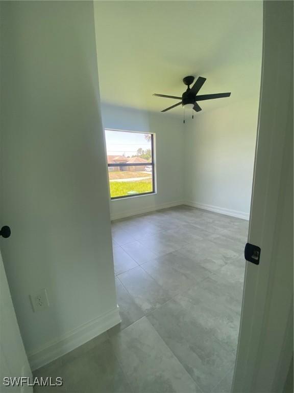 4108 35th St SW, Lehigh Acres, FL 33976 - empty room featuring a ceiling fan and baseboards