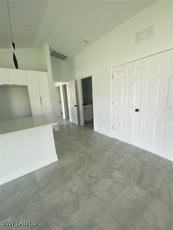 4108 35th St SW, Lehigh Acres, FL 33976 - unfurnished living room with vaulted ceiling and baseboards