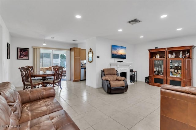 living room with light tile patterned floors, visible vents, and recessed lighting