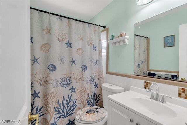 bathroom featuring a shower with shower curtain, toilet, tile walls, and vanity