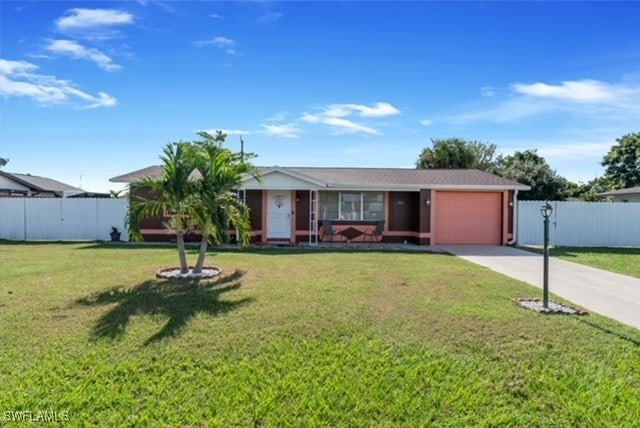 ranch-style house featuring a front lawn, fence, a garage, and driveway