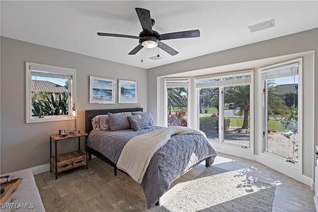 bedroom with a ceiling fan, baseboards, visible vents, light wood-style flooring, and access to exterior