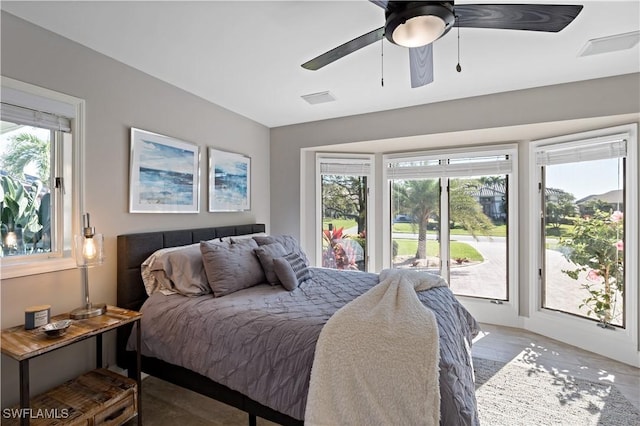 bedroom with access to exterior, ceiling fan, and wood finished floors