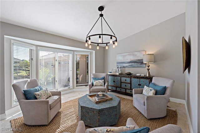 living room featuring a notable chandelier, baseboards, and vaulted ceiling