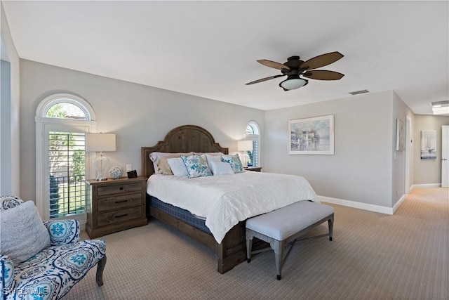 bedroom with ceiling fan, baseboards, visible vents, and light carpet