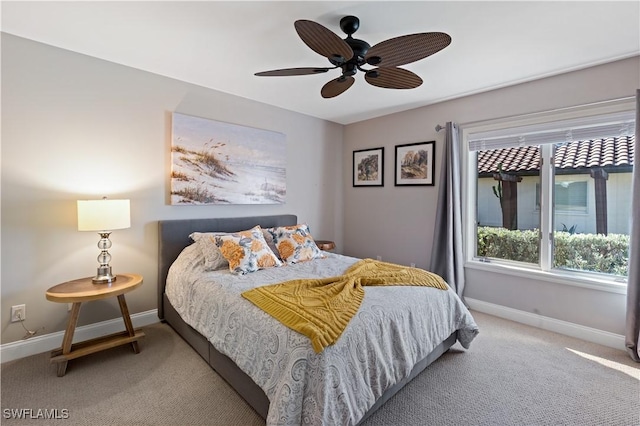 bedroom with carpet flooring, a ceiling fan, and baseboards