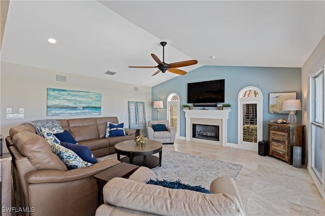 living area with visible vents, a fireplace, a ceiling fan, and vaulted ceiling