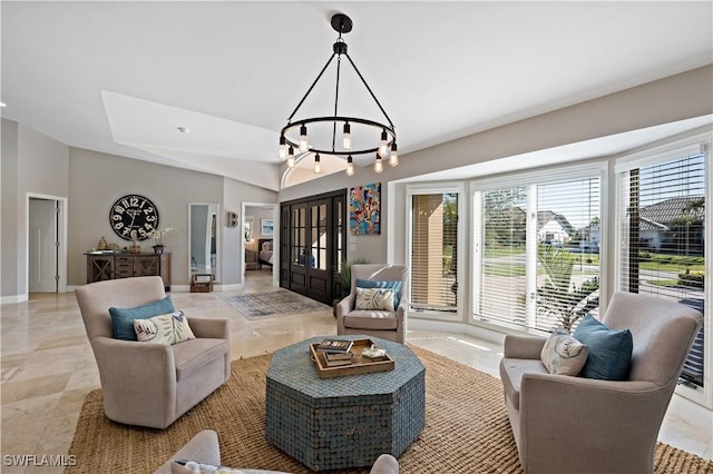 living area featuring an inviting chandelier and baseboards