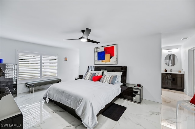 bedroom with visible vents, ensuite bathroom, marble finish floor, a ceiling fan, and a sink