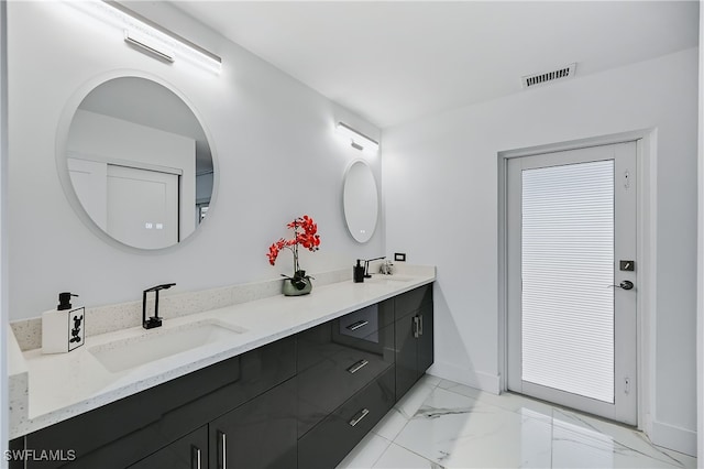 full bathroom featuring double vanity, visible vents, marble finish floor, and a sink