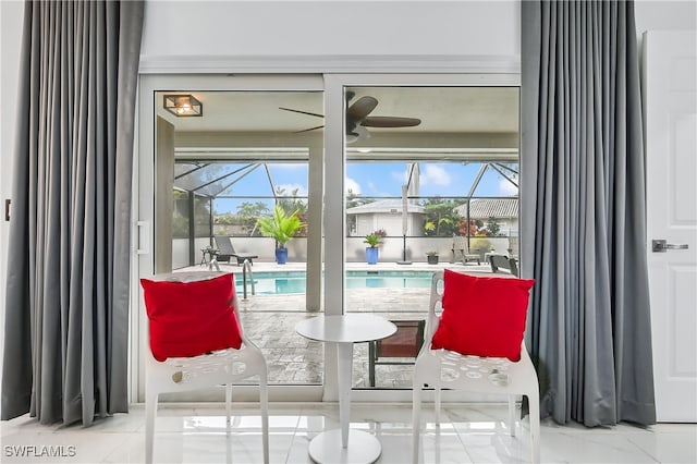 interior space featuring ceiling fan and a sunroom