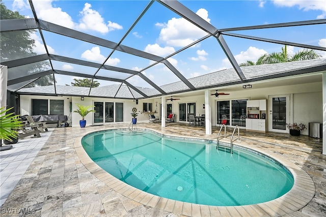 pool featuring a lanai, a ceiling fan, and a patio