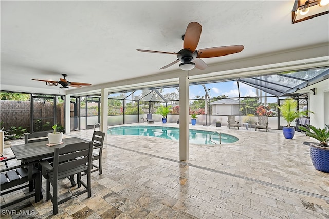 view of pool featuring a patio, fence, a lanai, and ceiling fan