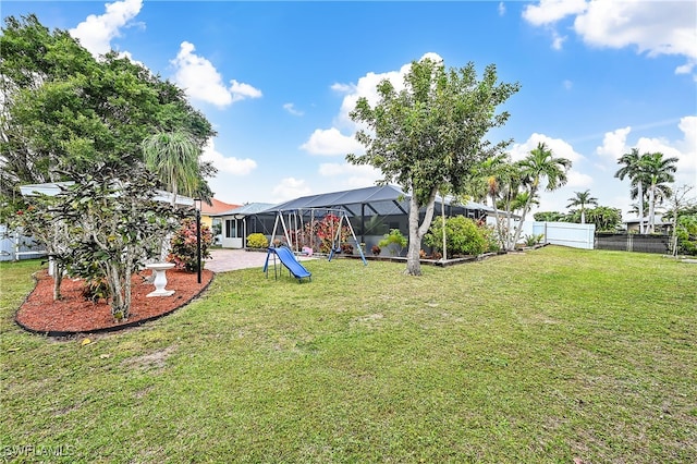 view of yard with glass enclosure, a patio area, and a fenced backyard