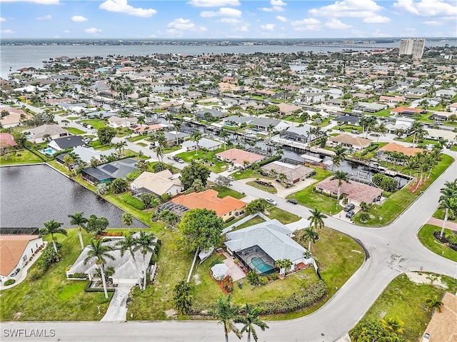 birds eye view of property with a residential view and a water view