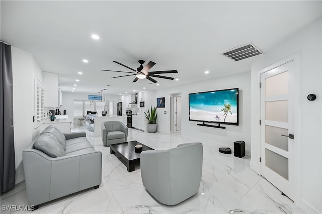 living room with visible vents, recessed lighting, marble finish floor, and a ceiling fan