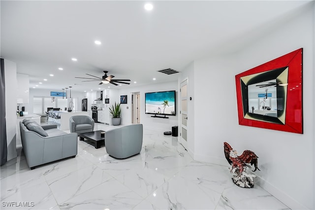 living area with recessed lighting, visible vents, marble finish floor, and ceiling fan