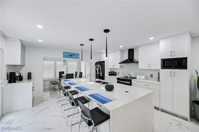 kitchen with a sink, black appliances, white cabinetry, wall chimney exhaust hood, and modern cabinets