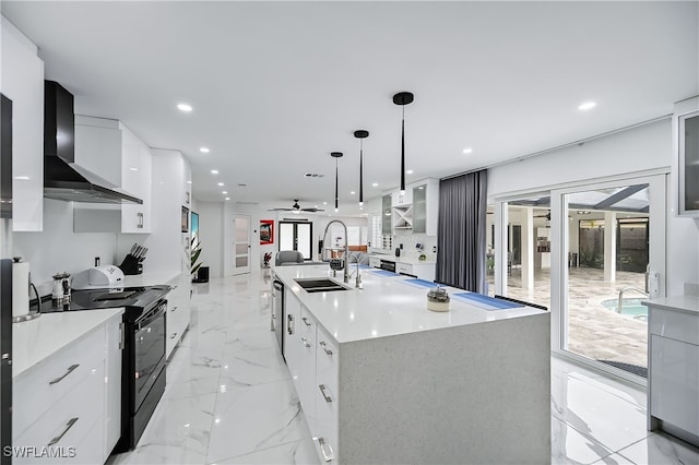 kitchen with wall chimney exhaust hood, marble finish floor, modern cabinets, black / electric stove, and a sink