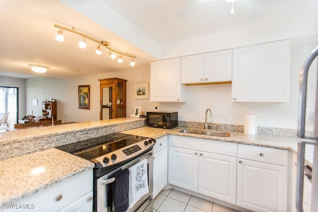 9209 Seminole Blvd Unit 117, Seminole, FL 33772 - kitchen with electric range, a sink, a peninsula, white cabinets, and black microwave