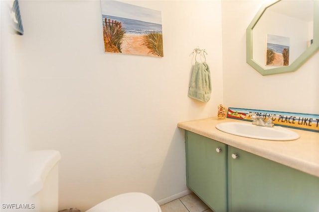 9209 Seminole Blvd Unit 117, Seminole, FL 33772 - bathroom with baseboards, toilet, vanity, and tile patterned flooring