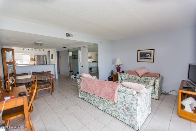 9209 Seminole Blvd Unit 117, Seminole, FL 33772 - living area with light tile patterned floors, visible vents, and a textured ceiling