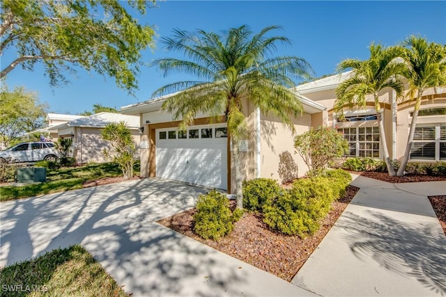 view of front of home featuring stucco siding, concrete driveway, and a garage