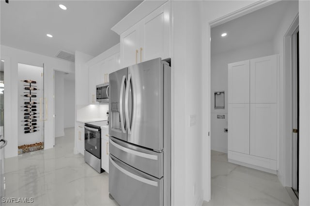 kitchen with visible vents, recessed lighting, stainless steel appliances, white cabinets, and marble finish floor