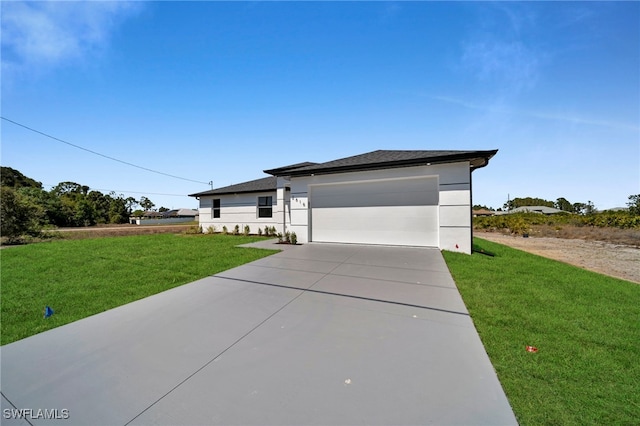 view of front of home with stucco siding, an attached garage, concrete driveway, and a front yard