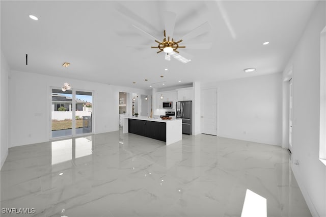 unfurnished living room featuring recessed lighting, marble finish floor, and a ceiling fan