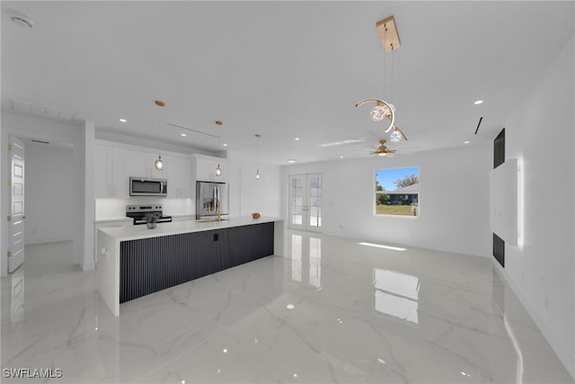 kitchen featuring recessed lighting, stainless steel appliances, french doors, white cabinetry, and marble finish floor