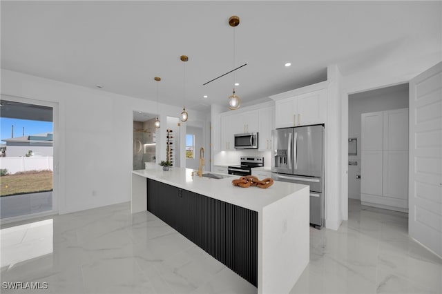 kitchen with marble finish floor, appliances with stainless steel finishes, light countertops, and white cabinetry