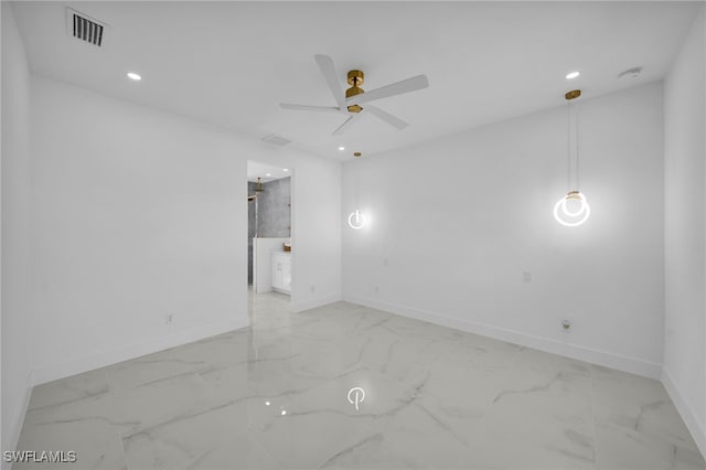 empty room with visible vents, baseboards, and marble finish floor