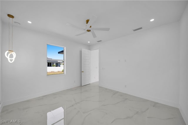 spare room with visible vents, marble finish floor, and baseboards