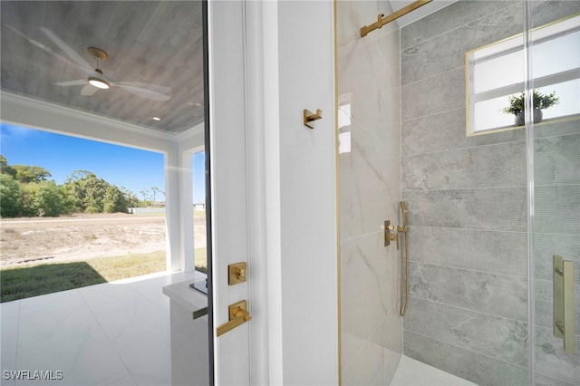 full bath with a wealth of natural light, tiled shower, and crown molding